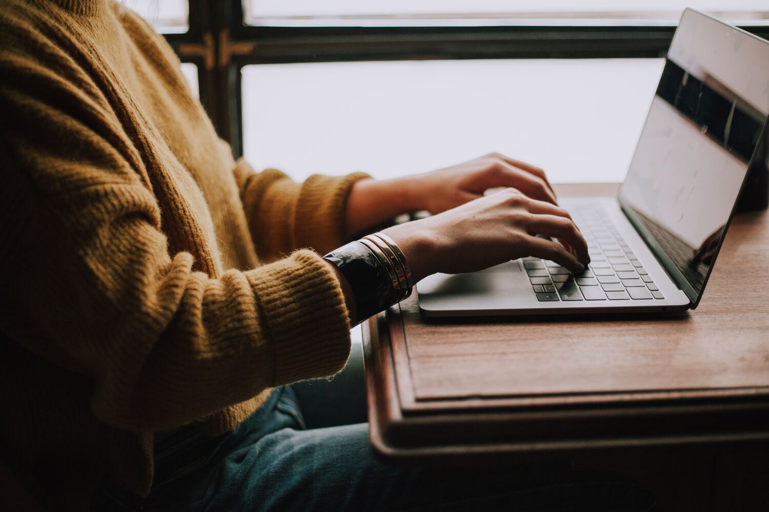 A Young Woman Researching Her Laptop For APHR Exam