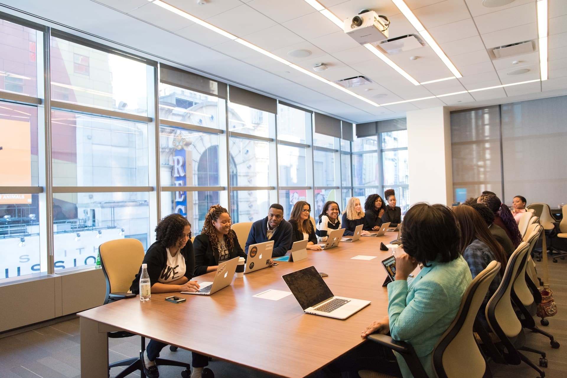 A Conference Room Meeting Made Up Of A Diverse Group Of Employees