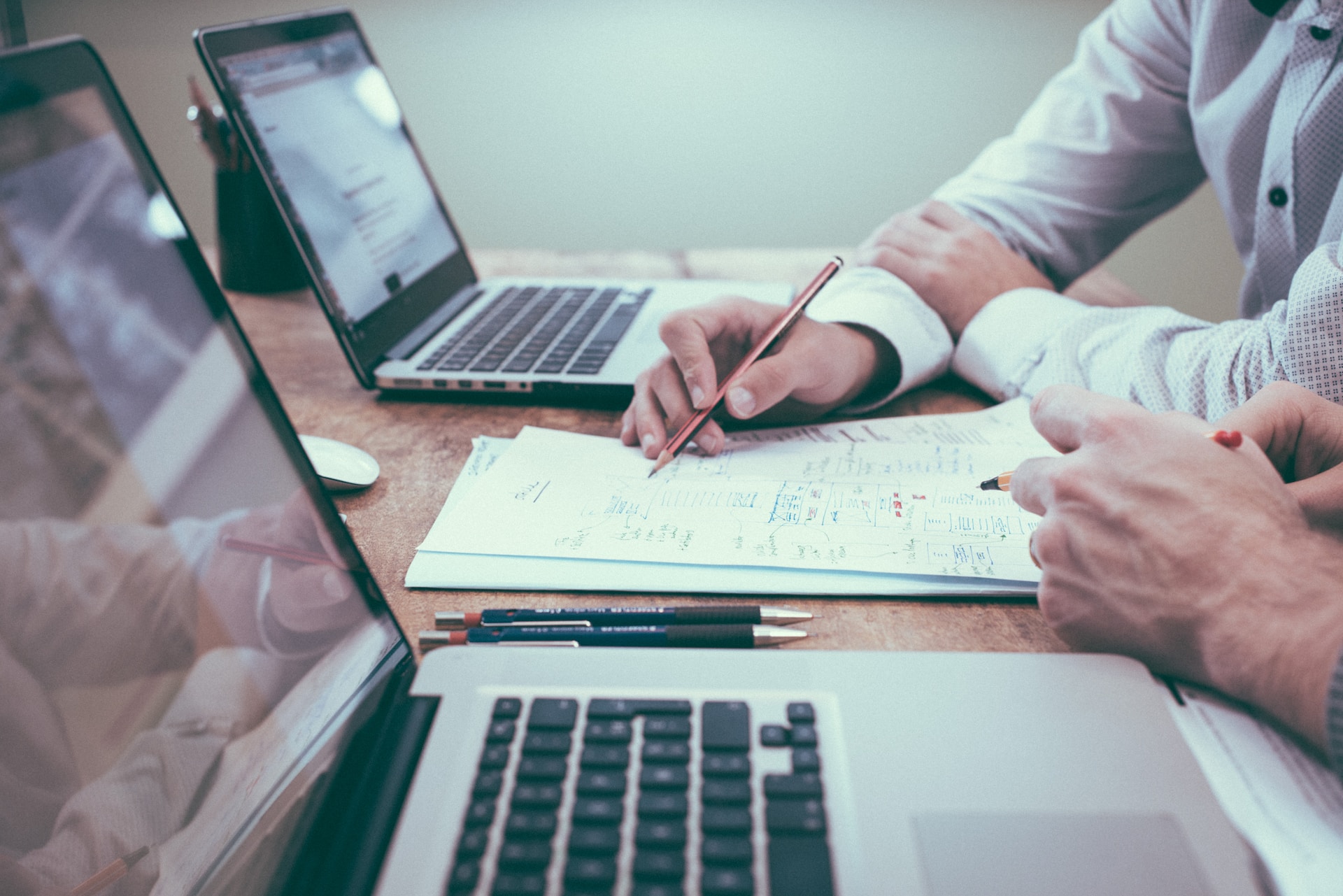 A Compensation Manager Meeting With An Employee Going Over Paperwork