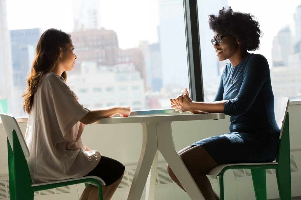 Women from HR leadership talking at a table