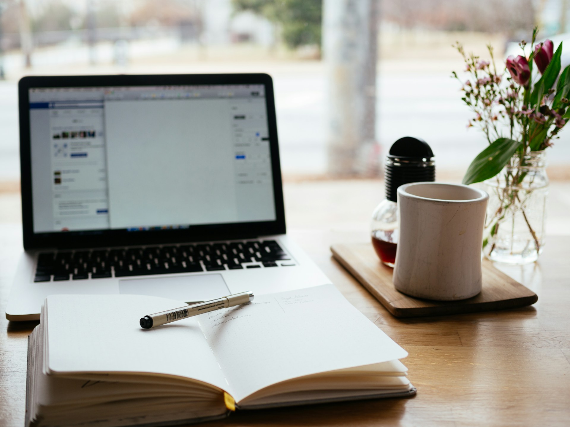 A Study Space With An Open Notebook Next To A Laptop With Online PHR Certification Prep