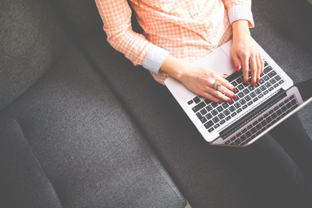 A person studying online SPHR certification prep on their laptop on a couch