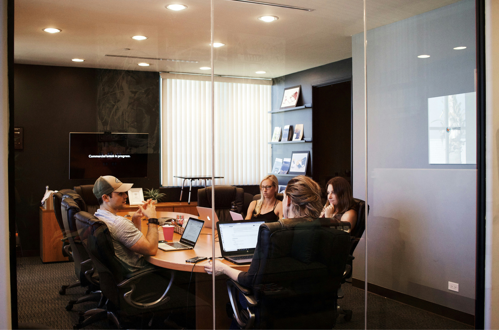 A Conference Room With People Having A Meeting About HR Leadership Around A Table