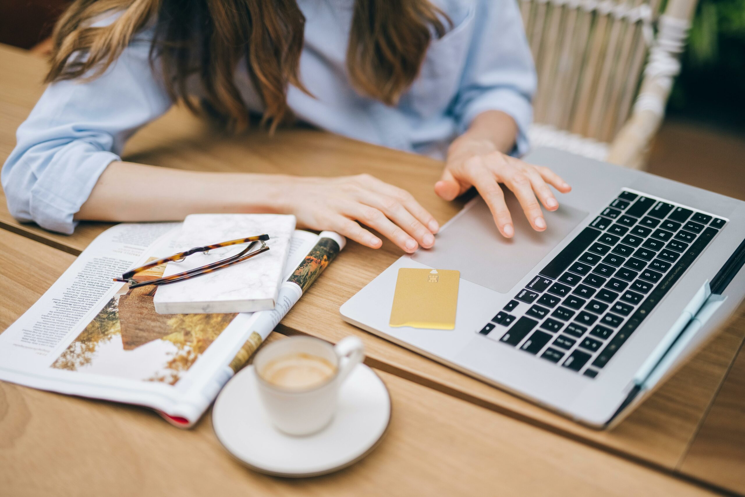 A Woman Completing A Type Of HR Certification At Her Laptop With A Cup Of Coffee And A Notepad