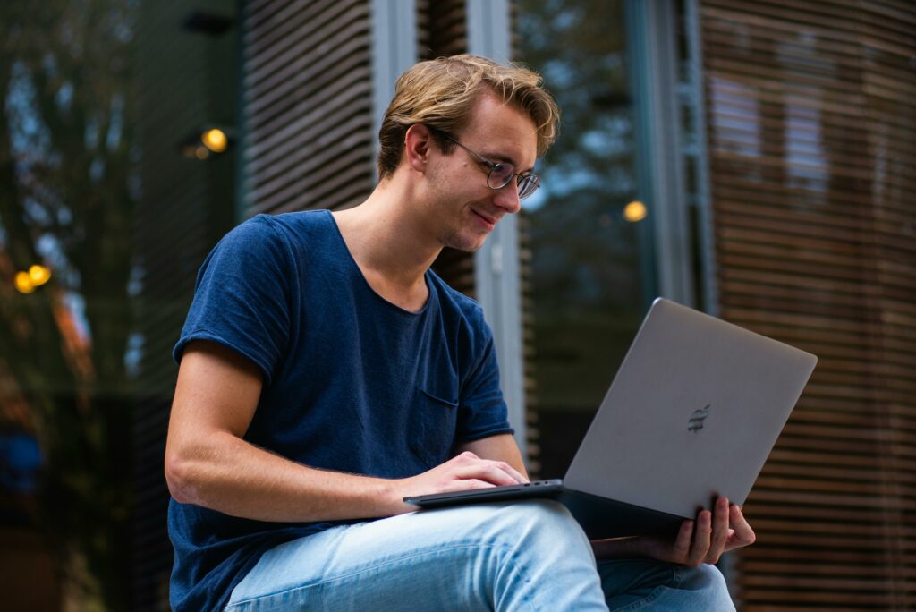 A man working on a laptop outside