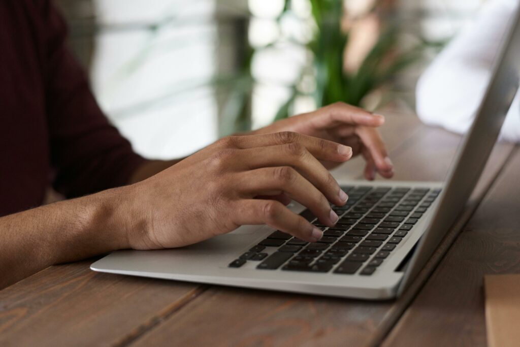 A woman working on a laptop at her desk